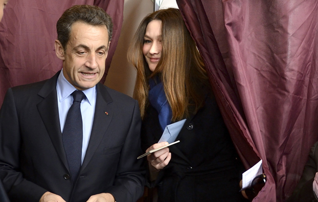 France's President and UMP party candidate for the 2012 French presidential elections Nicolas Sarkozy exit the voting booth before casting his ballots in the first round of 2012 French presidential election at a polling station in Paris